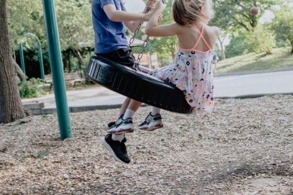 children on horizontal tire swing